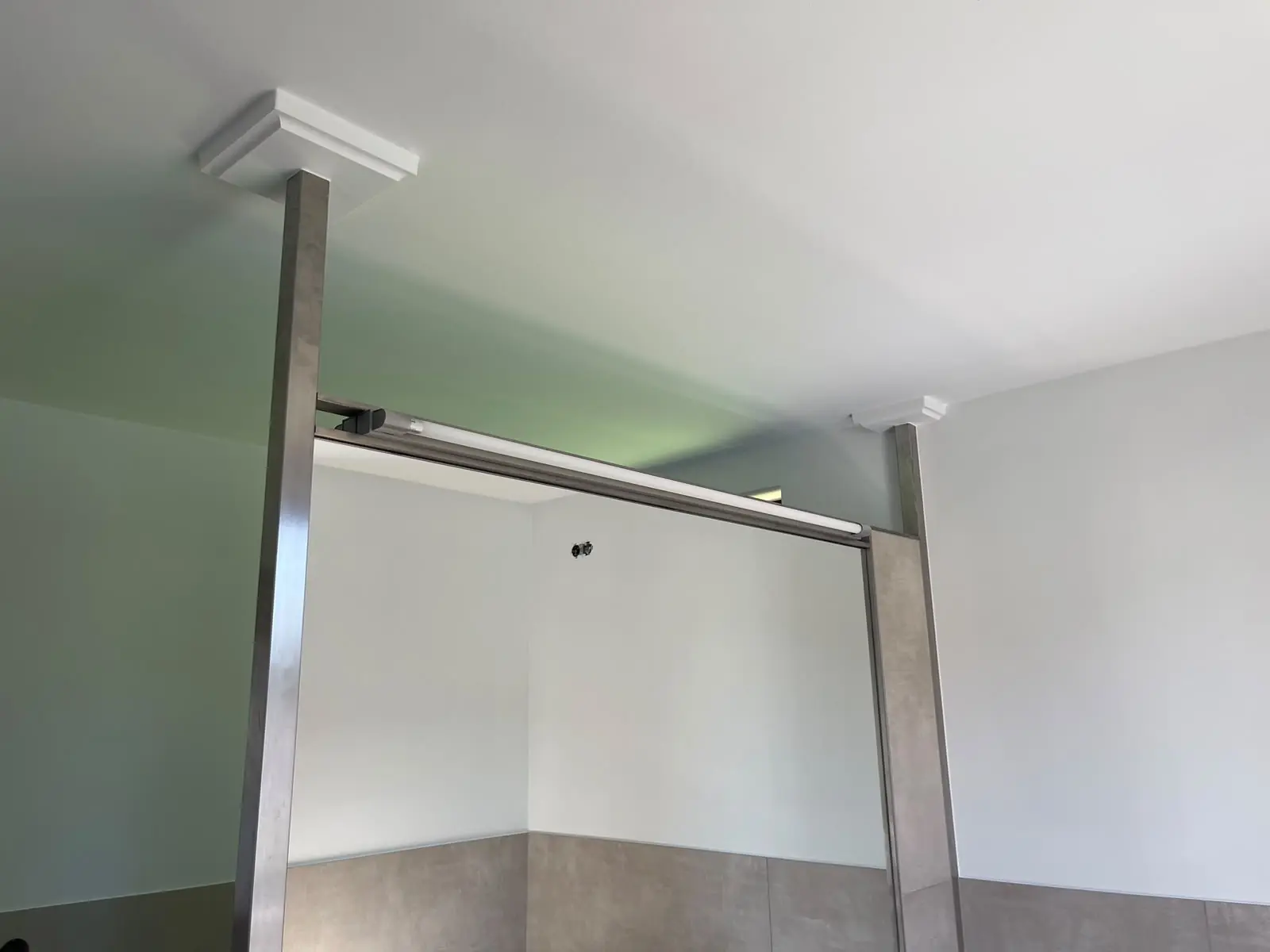Deckendetail mit neuem Stuckelement an einer Duschabtrennung